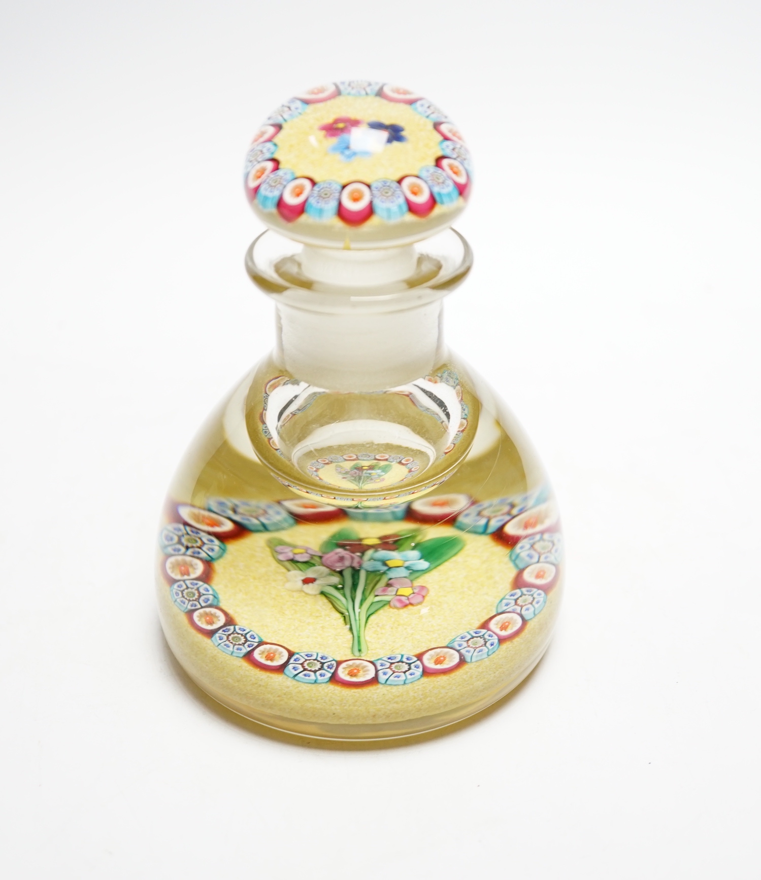 A rare Paul Ysart ‘small flower bouquet’ glass inkwell or bottle and stopper, Caithness period, scratched signature ‘P. Ysart’, sand coloured jasper ground, 10cm diameter, 14cm high